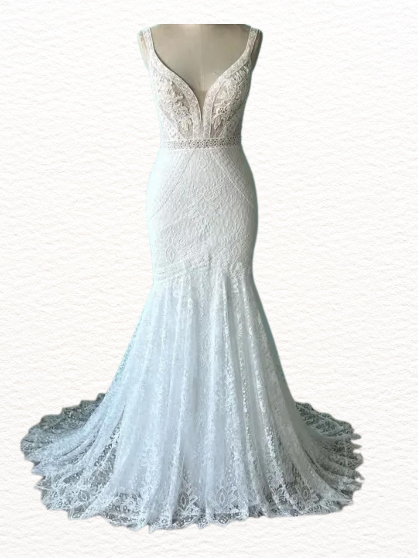 May include: A white, floor-length wedding dress with a mermaid silhouette. The bodice features a deep V-neckline and delicate lace detailing. A thin beaded belt accentuates the waist. The skirt flares out into a flowing train.